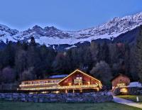 a building with christmas lights in front of a mountain at Sweet Cherry - Boutique &amp; Guesthouse Tyrol in Innsbruck