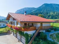 a house with a balcony with flowers on it at Obinghof in Söll