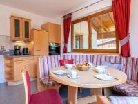 a kitchen and dining room with a table and chairs at Obinghof in Söll