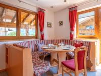 a dining room with a table and chairs at Obinghof in Söll