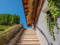 a stairway with flowers on a building at Obinghof in Söll