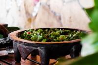 ビーチコンバー島にあるビーチコンバー アイランド リゾートのテーブルの上に野菜が入った鍋が置かれている