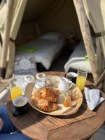 a table with a plate of food and drinks on it at Camping Les Vosges du Nord in Oberbronn