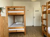 a room with two bunk beds and a hallway at Maison avec Jardin près des Plages in Le Bernard