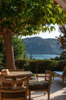 a table and chairs under a tree with a view at Résidence Marina Di Santa Giulia in Porto-Vecchio