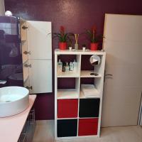 a bathroom with a sink and a shelf with cosmetics at Maison calme&#47;Chambre privée&#47;Clim+TV&#47;Pétit dejeuner inclu&#47;tout confort in Nevers