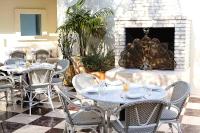 een patio met tafels en stoelen en een open haard bij Short Stories Hotel Near The Grove in Los Angeles