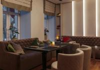 a dining room with a table and chairs at Continental Hotel in Odesa