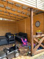 a patio with a toy car in front of a house at Guest house Shulc in Mizhhirya