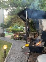 a barbecue grill with smoke coming out of it at Guest house Shulc in Mizhhirya