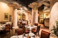 a restaurant with tables and chairs in a room with columns at Eldorado Reno, A Caesars Destination in Reno