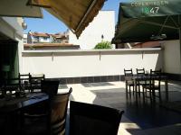 a restaurant with tables and chairs in a patio at Modern & Elegant City Center Apartments in Plovdiv