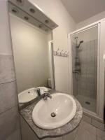 a white bathroom with a sink and a shower at Appartement F2 entier près gare RER et SNCF in Conflans-Sainte-Honorine