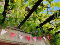 a red and white banner hanging from a tree at La Blatière French Cottages in La Chapelle-Saint-Étienne