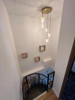 a hallway with a staircase with a light fixture at Villa moderne 3 chambres double , proche de la mer, le Micocoulier quartier sainte Marguerite in La Garde