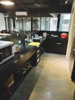 a large kitchen with black counters and a microwave at Main Inn Taipei in Taipei