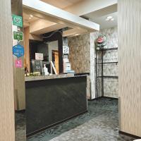 a lobby with a black counter and a mirror at Main Inn Taipei in Taipei