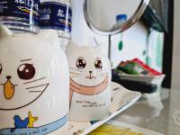 two hello kitty vases sitting on a shelf at Sunny Sun B&amp;B in Taitung City