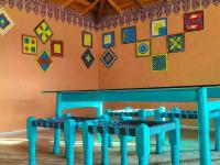 a room with two blue benches against a wall with kites at HODKA RANN STAY Resort in Bherandiāla
