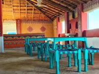 a row of blue chairs in a room at HODKA RANN STAY Resort in Bherandiāla