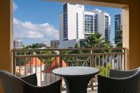 a balcony with a table and chairs and a view of a city at The Ritz-Carlton, Sarasota in Sarasota