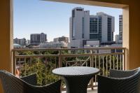 a table and chairs on a balcony with a city view at The Ritz-Carlton, Sarasota in Sarasota