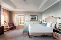 a bedroom with a large white bed and a chair at The Ritz-Carlton, Sarasota in Sarasota