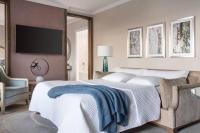 a bedroom with a bed and a tv on a wall at The Ritz-Carlton, Sarasota in Sarasota