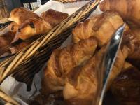 a bunch of loaves of bread and croissants in baskets at KYRIAD HONFLEUR - La Riviere Saint Sauveur in Honfleur