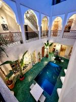 an indoor swimming pool in a building with plants at Riad Citrus By La Siredrah in Marrakech