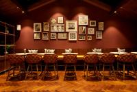 a dining room with tables and chairs and pictures on the wall at Taj Holiday Village Resort & Spa, Goa in Candolim