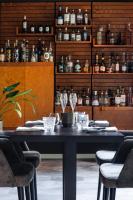 a dining room with a black table and chairs at de Lochemse Berg in Barchem