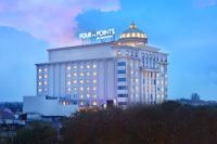 a building with a sign on the top of it at Four Points by Sheraton Medan in Medan