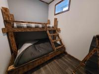 two bunk beds in a room with a window at Gîte de la Ferme de la Comté in Le Thillot
