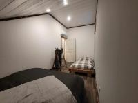 a bedroom with a bed in a room with a door at Gîte de la Ferme de la Comté in Le Thillot