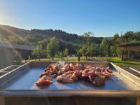 a grill with a bunch of meat on it at Gîte de la Ferme de la Comté in Le Thillot