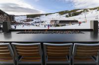 a group of chairs sitting in front of a ski slope at Grand Colorado on Peak 8 in Breckenridge