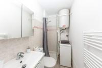 a white bathroom with a toilet and a sink at Superbe studio avec balcon vue mer&#47;climatisation in Cagnes-sur-Mer
