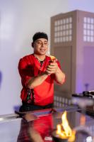 a man in a red shirt holding a drink at Casa Blue Resort in Marsa Alam City