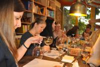 a group of people sitting at a table with wine glasses at Boutique Hotel Casa Art in Oreshak