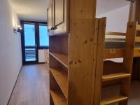 a room with two bunk beds and a kitchen at Studio Plagne Aime 2000, 1 pièce, 4 personnes - FR-1-181-2618 in Aime-La Plagne