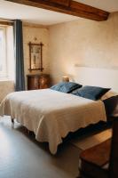 a bedroom with a large bed and a window at Les Granges Pelloquin in Bernières-sur-Mer