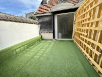 a garden with a walkway in front of a house at Maputo - Appartement climatisé in Reims