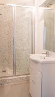 a white bathroom with a shower and a sink at Beautiful &amp; Bright Apartment Near Pigalle in Paris