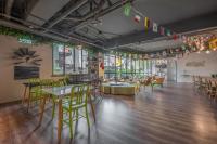 a room with tables and chairs and colorful flags at Light Hostel - Tainan in Tainan