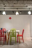 a table with colorful chairs in a room at Light Hostel in Chiayi City