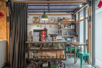 a room with a table and some tables and chairs at Light Hostel in Chiayi City