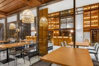 a restaurant with wooden tables and chairs and windows at Hotel Aubamar Suites & Spa in Playa de Palma