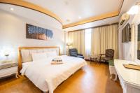 a hotel room with a bed and a desk at Wenpin Hotel - Pier 2 in Kaohsiung