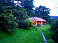 a house in the middle of a yard with a pathway at The Road&#39;s End in Gonikoppal